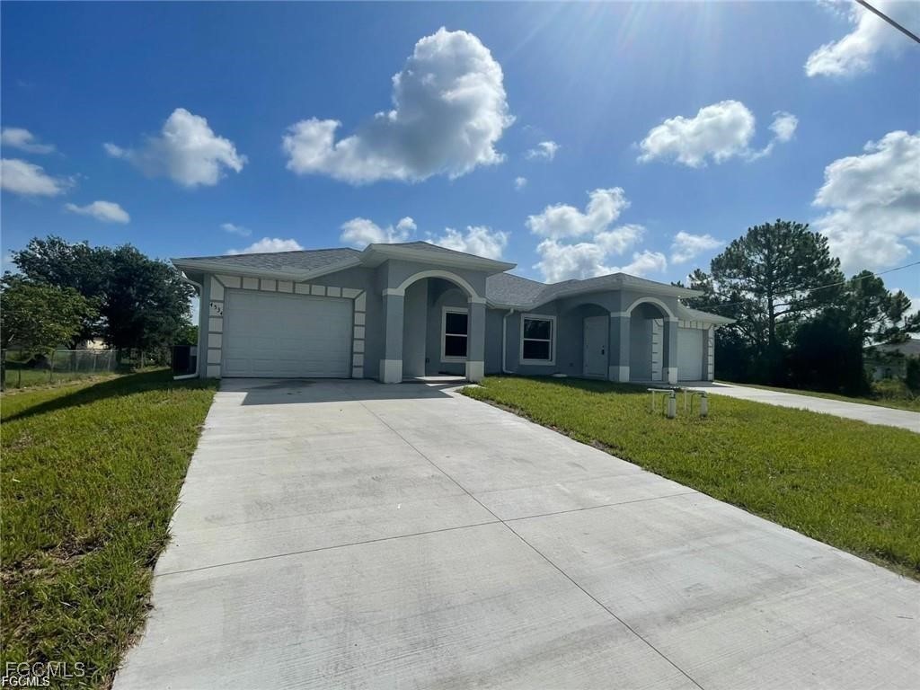 4657-4659 26th Street Southwest Lehigh Acres, FL 33973 - Photo 2 of 24 a house view with a garden space
