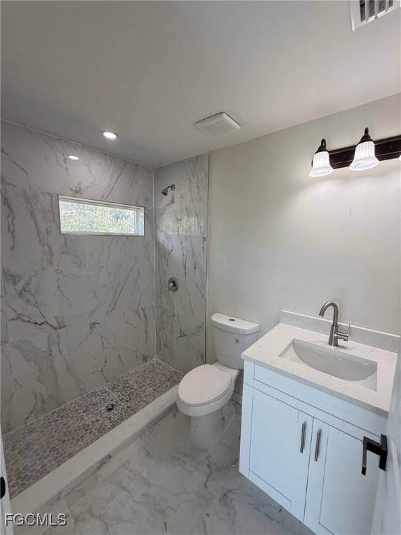 4657-4659 26th Street Southwest Lehigh Acres, FL 33973 - Photo 21 of 24 a bathroom with a sink a toilet and shower