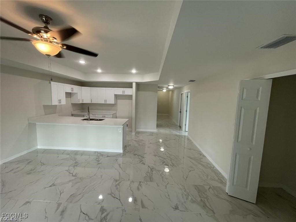 4657-4659 26th Street Southwest Lehigh Acres, FL 33973 - Photo 5 of 24 a view of a kitchen with a sink and chandelier fan