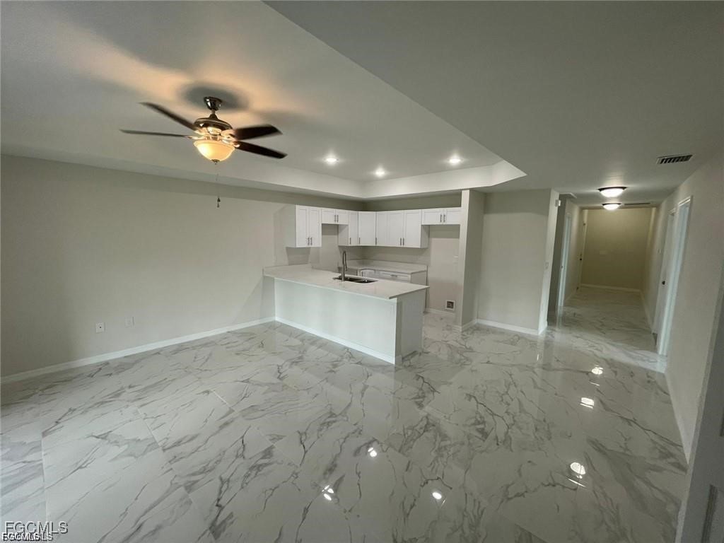 4657-4659 26th Street Southwest Lehigh Acres, FL 33973 - Photo 6 of 24 a view of a kitchen with a sink and a refrigerator