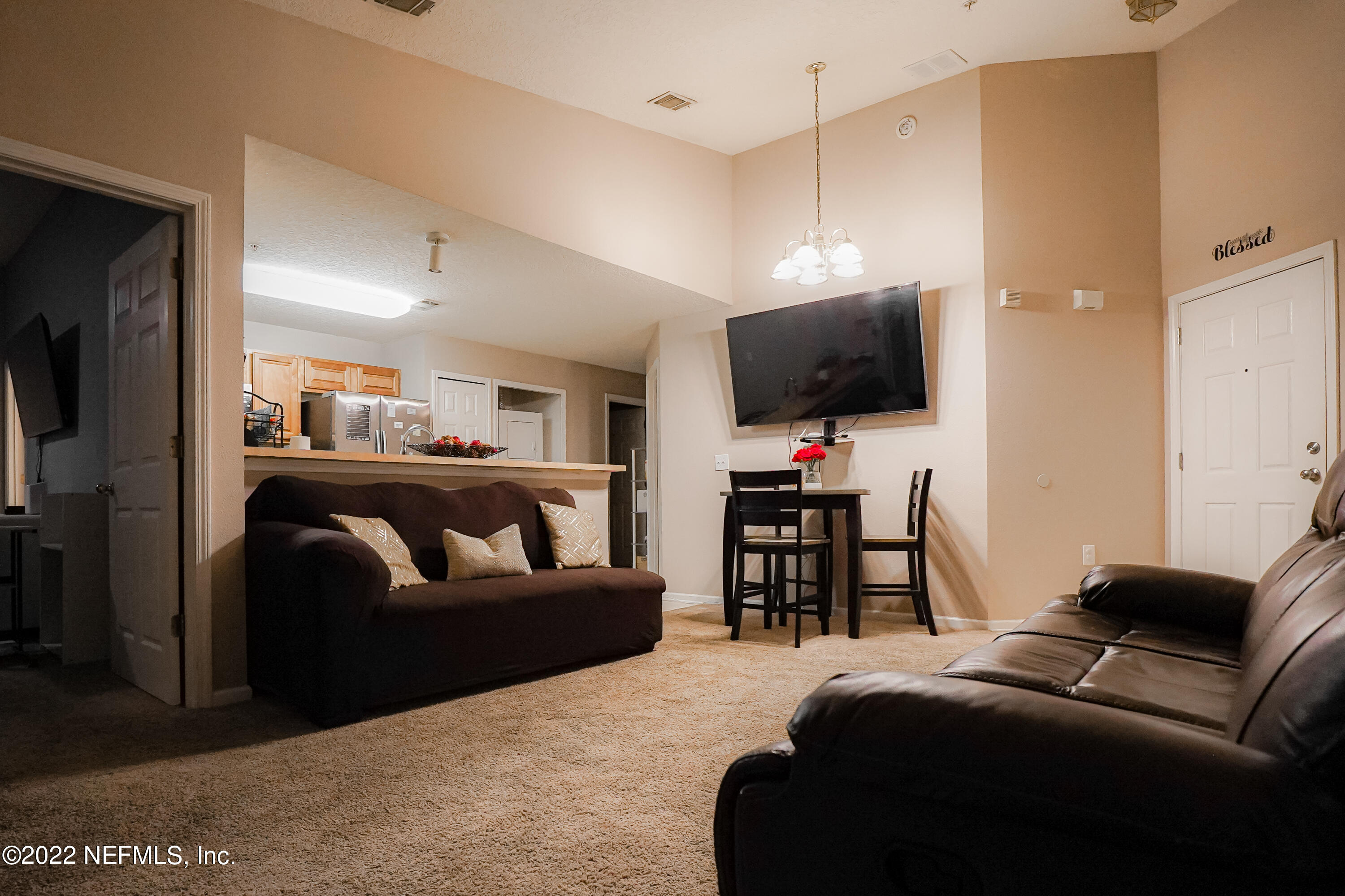 7920 Merrill Road, Unit 1613 Jacksonville, FL 32277 - Photo 5 of 16 a bedroom with a bed and a flat screen tv