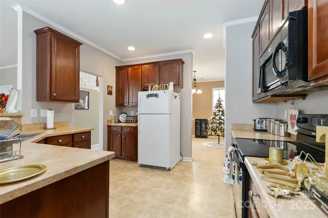 a kitchen with refrigerator and cabinets