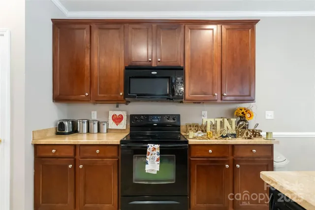 a kitchen with a sink a stove and cabinets