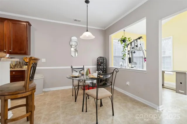 a dining room with furniture a window and a chandelier