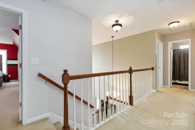 a view of a hallway with closet and stairs