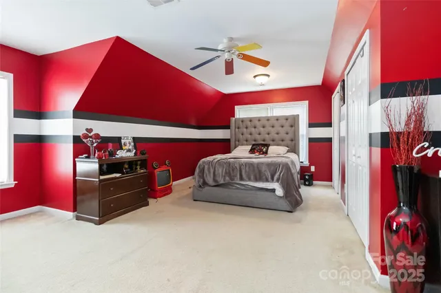 a bed room with a bed and a television