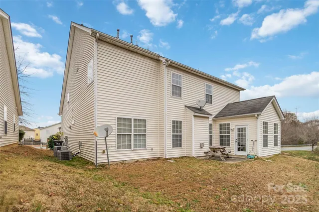 a wooden bench sitting in front of a house