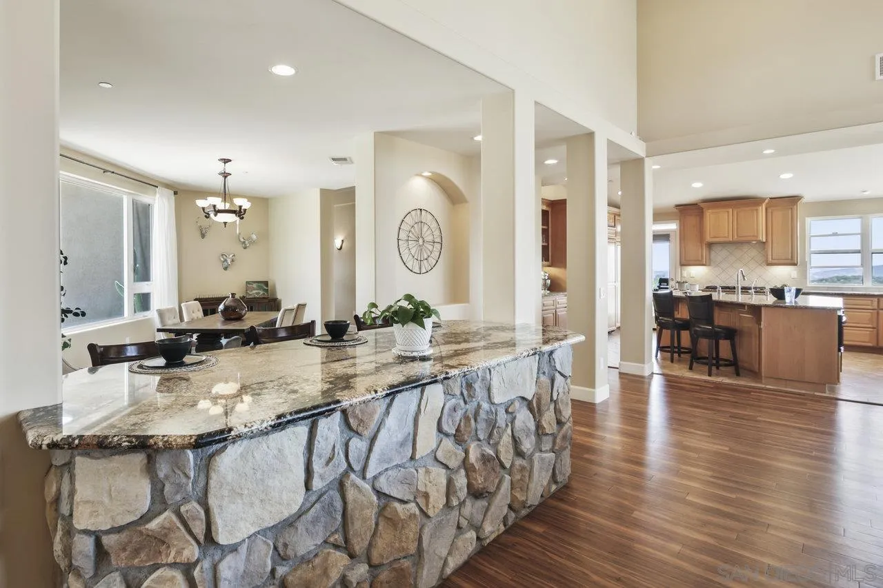 13192 Yerba Valley Way Lakeside, CA 92040 - Photo 12 of 58 a large dining hall with stainless steel appliances granite countertop a stove a sink a dining table and chairs