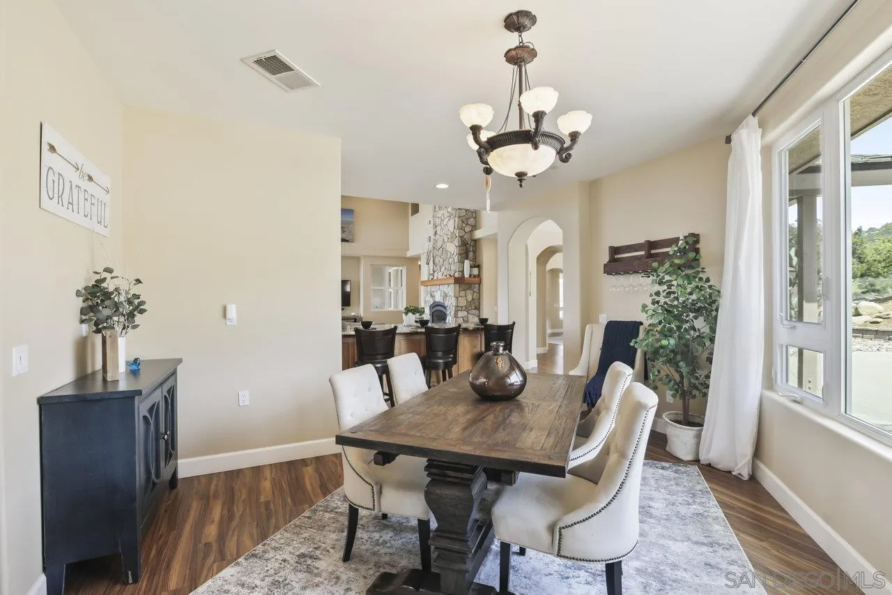 13192 Yerba Valley Way Lakeside, CA 92040 - Photo 14 of 58 a view of a dining room with furniture window and wooden floor