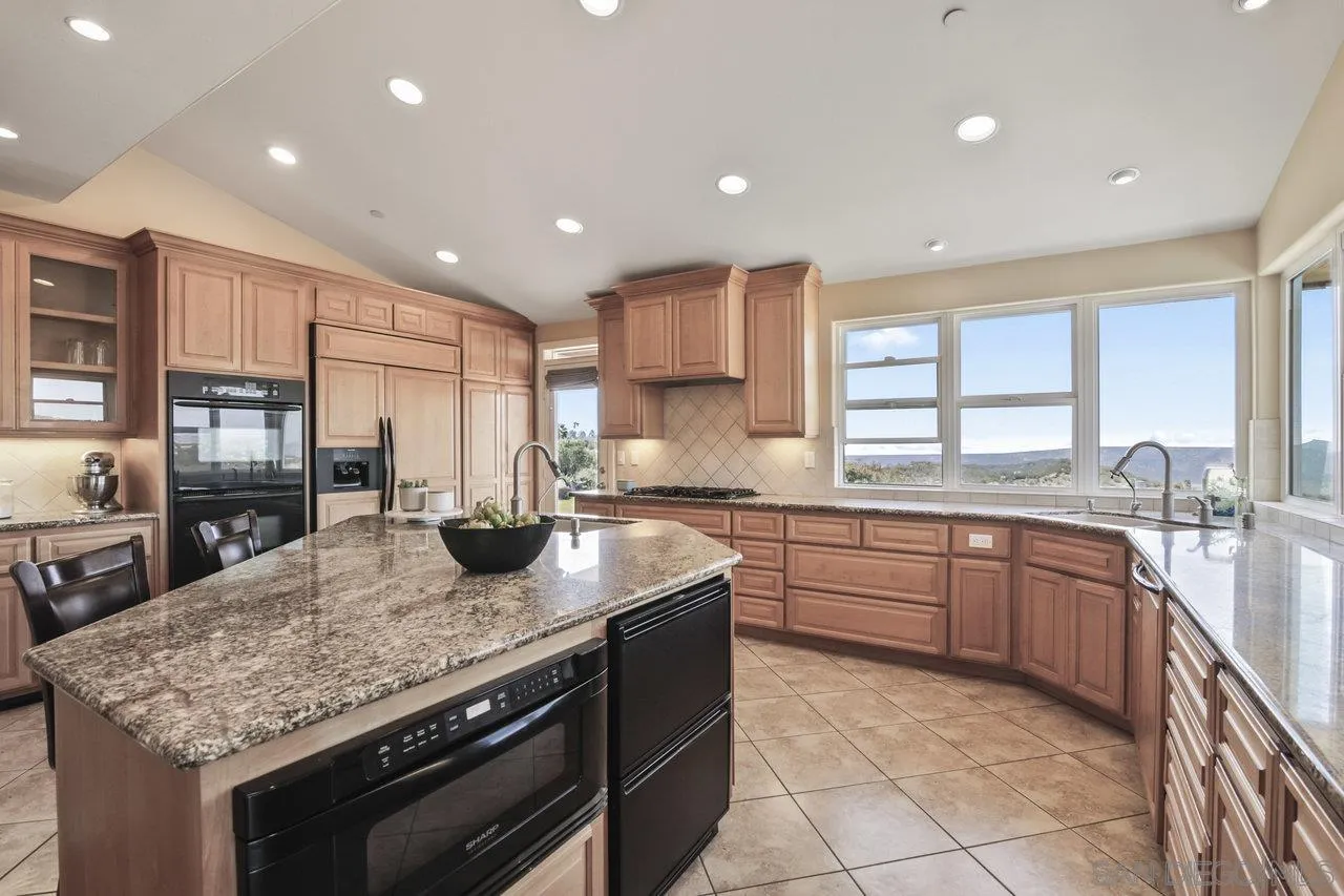 13192 Yerba Valley Way Lakeside, CA 92040 - Photo 18 of 58 a kitchen with granite countertop stainless steel appliances and sink
