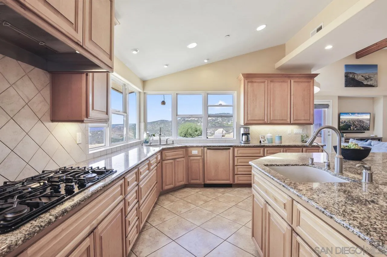 13192 Yerba Valley Way Lakeside, CA 92040 - Photo 20 of 58 a kitchen with a sink stove top oven and cabinets