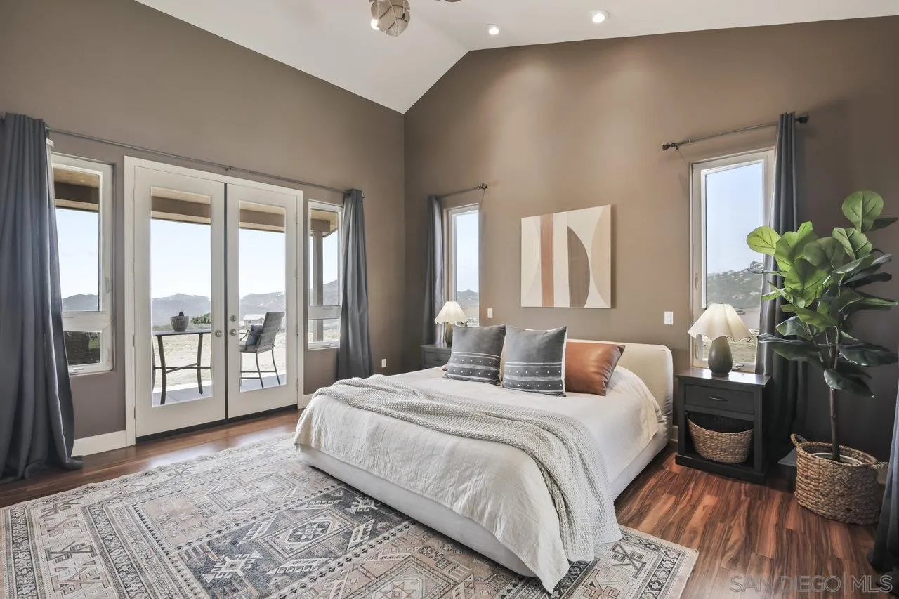 13192 Yerba Valley Way Lakeside, CA 92040 - Photo 26 of 58 a bedroom with a large bed and a large window