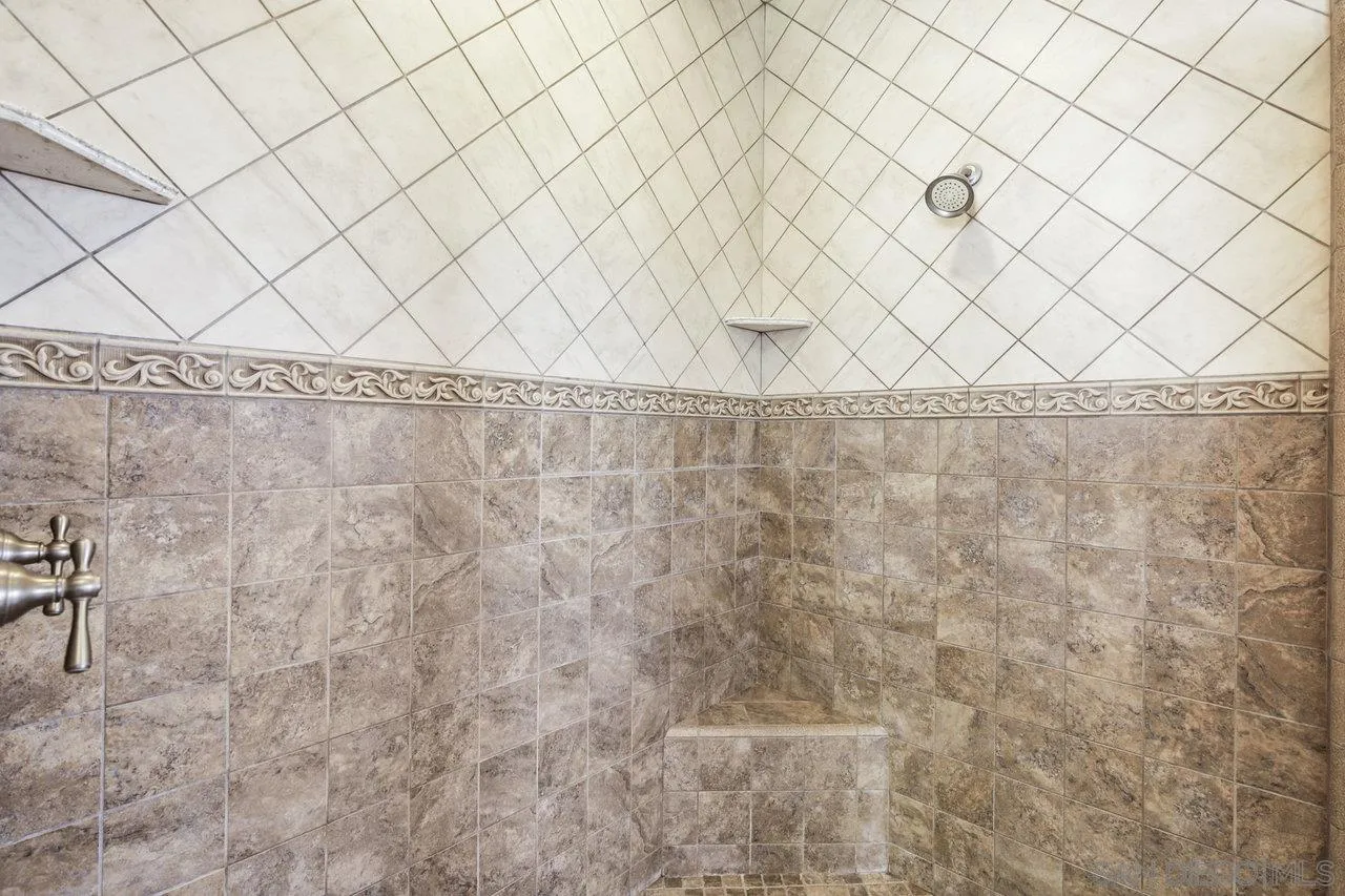 13192 Yerba Valley Way Lakeside, CA 92040 - Photo 29 of 58 a bathroom with a white wall and a shower curtain
