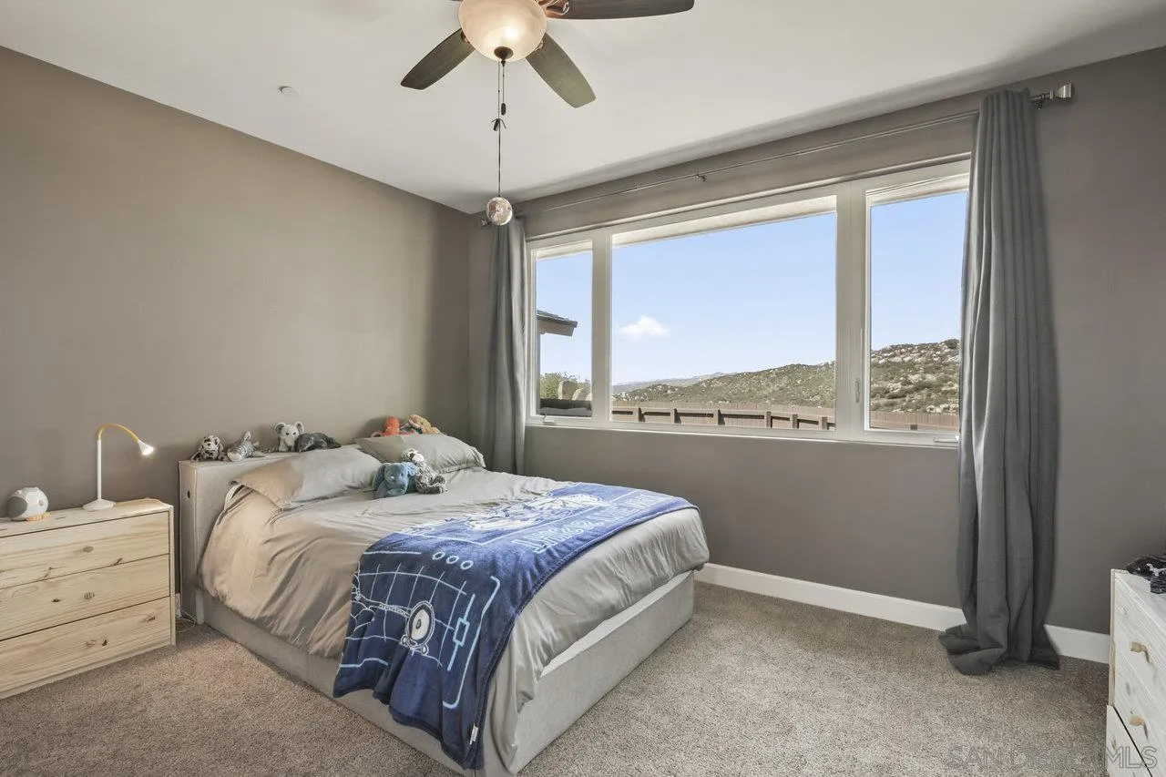 13192 Yerba Valley Way Lakeside, CA 92040 - Photo 32 of 58 a bedroom with a large bed and a window