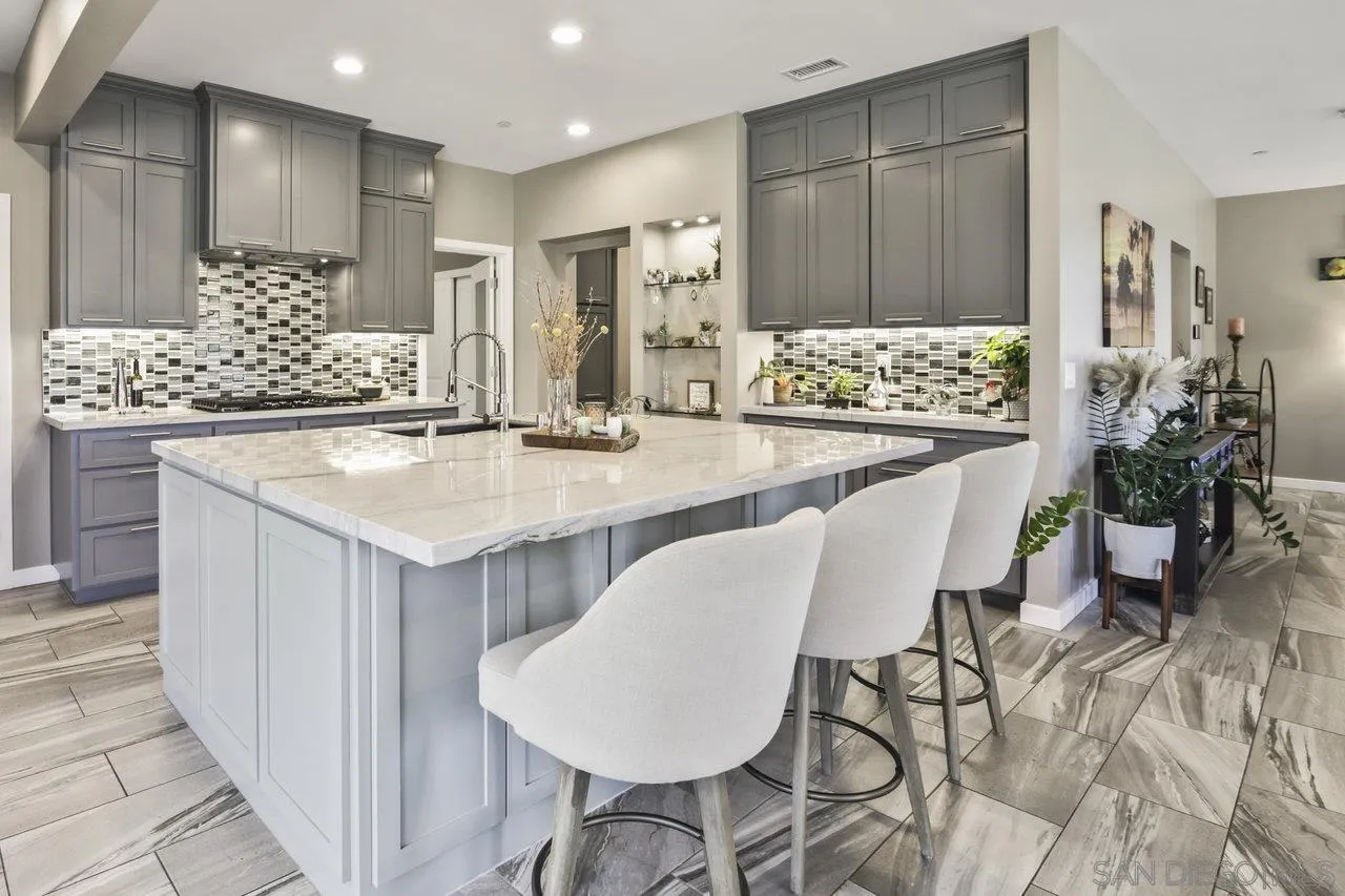 13192 Yerba Valley Way Lakeside, CA 92040 - Photo 35 of 58 a kitchen with kitchen island granite countertop a table and chairs in it