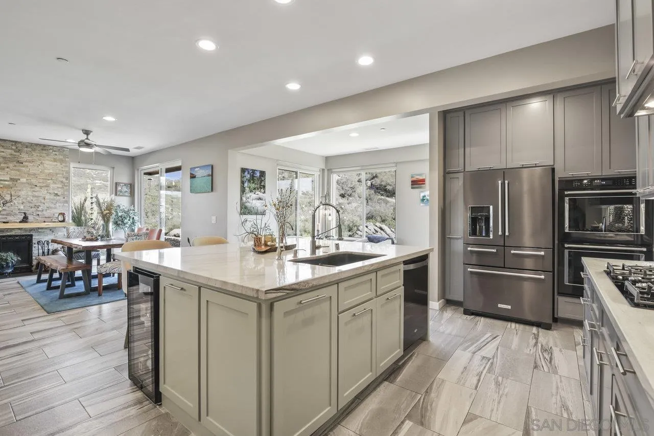 13192 Yerba Valley Way Lakeside, CA 92040 - Photo 38 of 58 a kitchen with stainless steel appliances granite countertop a lot of counter space and wooden floor