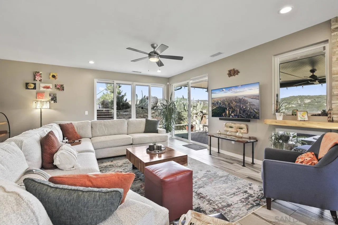 13192 Yerba Valley Way Lakeside, CA 92040 - Photo 40 of 58 a living room with furniture a large window and a flat screen tv