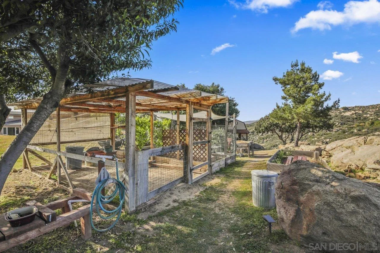 13192 Yerba Valley Way Lakeside, CA 92040 - Photo 49 of 58 a view of a patio with a table and chairs under an umbrella