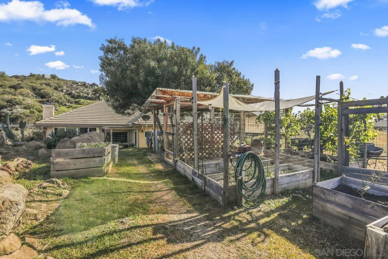 13192 Yerba Valley Way Lakeside, CA 92040 - Photo 51 of 58 a view of a patio with table and chairs with wooden fence