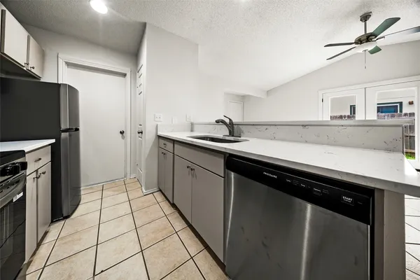 a kitchen with stainless steel appliances a sink stove and cabinets
