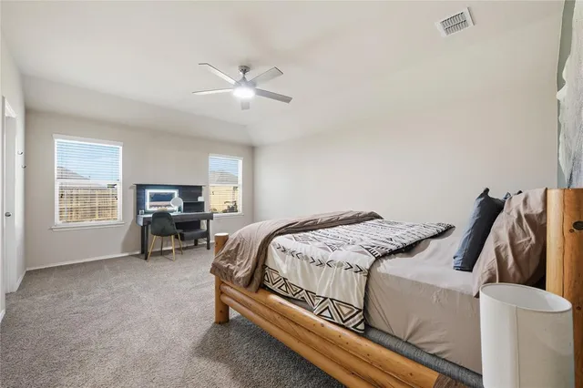 a bed sitting in a bedroom next to a window