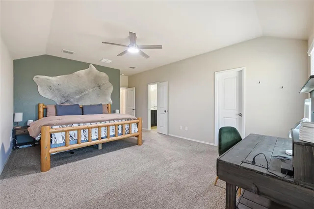 a bedroom with a bed window and dresser