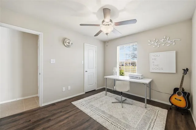 a workspace with wooden floor and windows