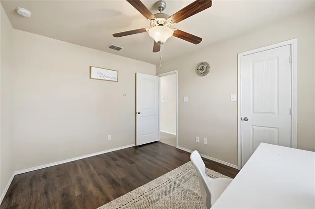 a bedroom with a bed and a ceiling fan