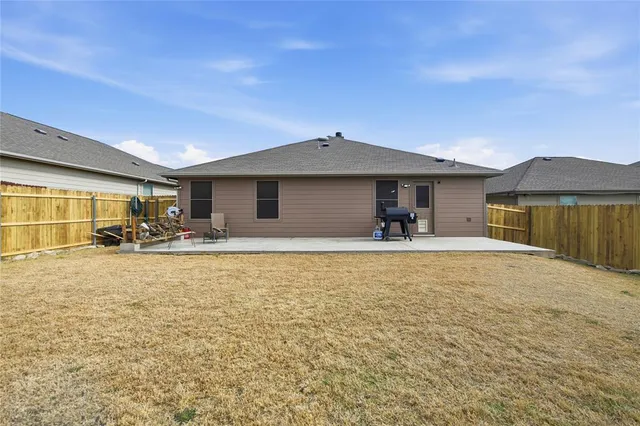a view of a house with backyard porch and furniture