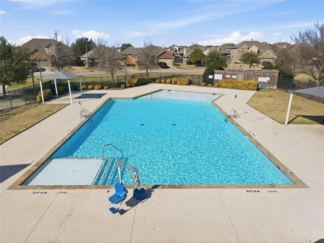 a view of a swimming pool and lounge chairs