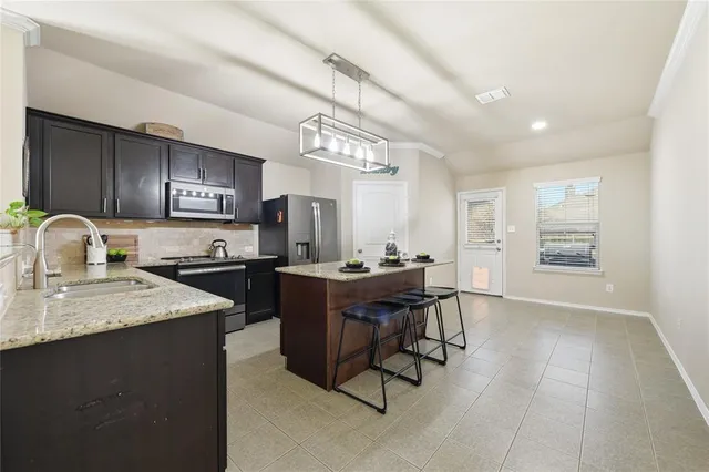 a kitchen with a sink appliances and cabinets