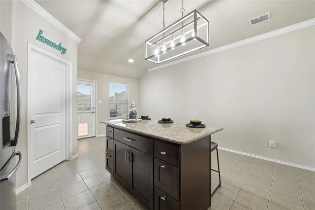 a kitchen with a sink a refrigerator and cabinets