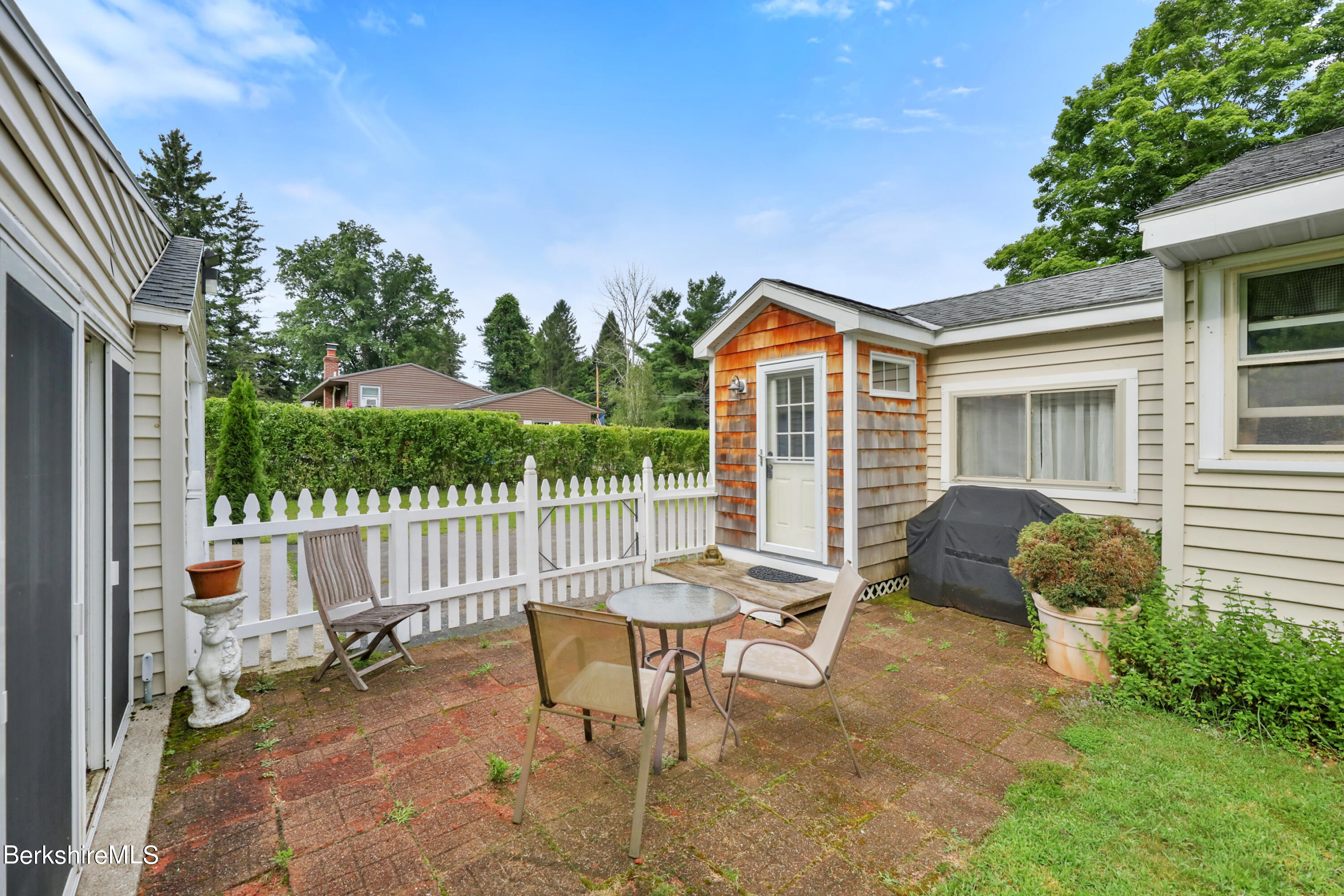 16 East New Lenox Road Lenox, MA 01240 - Photo 19 of 28 a backyard of a house with table and chairs