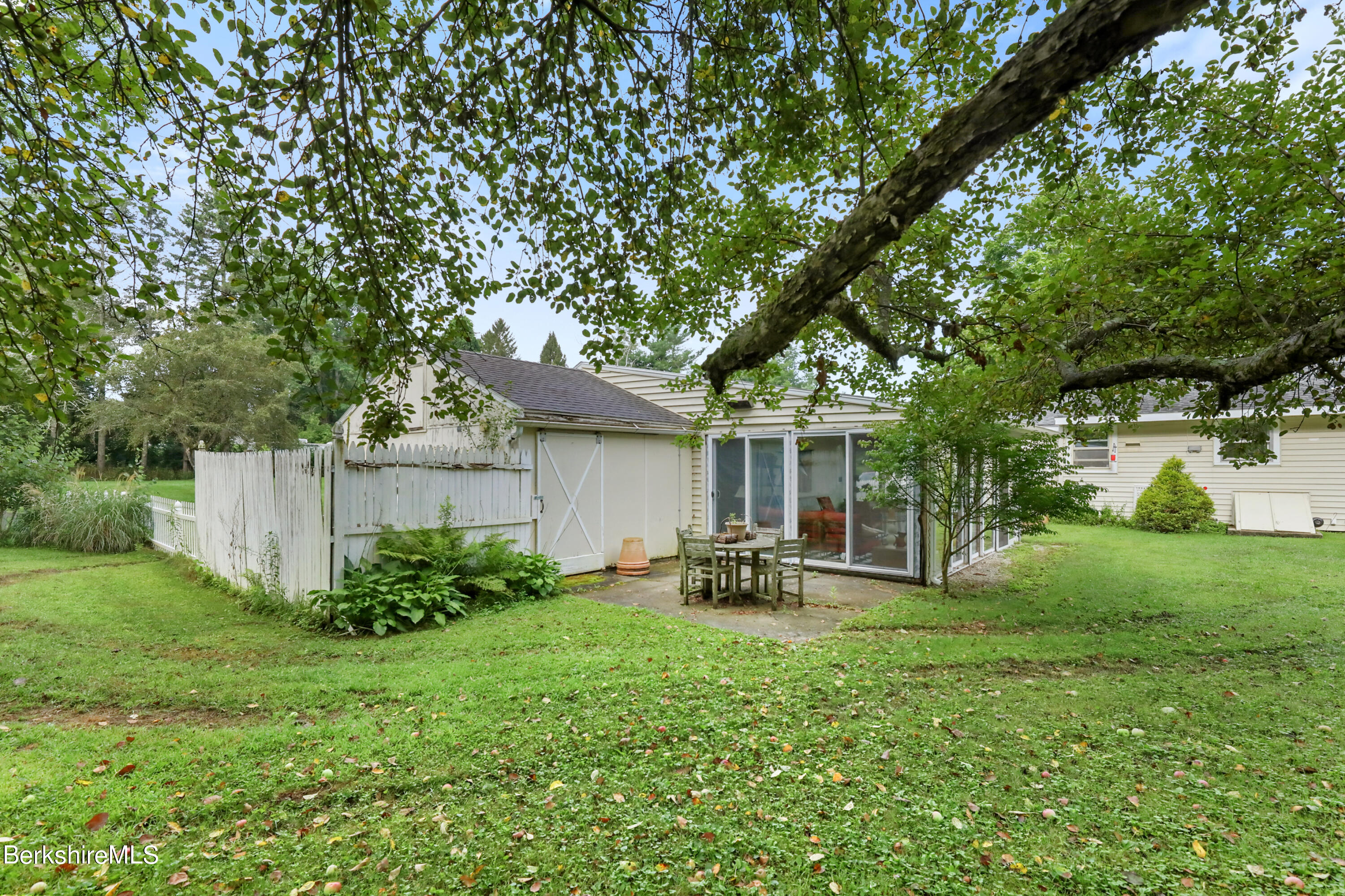 16 East New Lenox Road Lenox, MA 01240 - Photo 26 of 28 a view of a backyard with table and chairs and a large tree