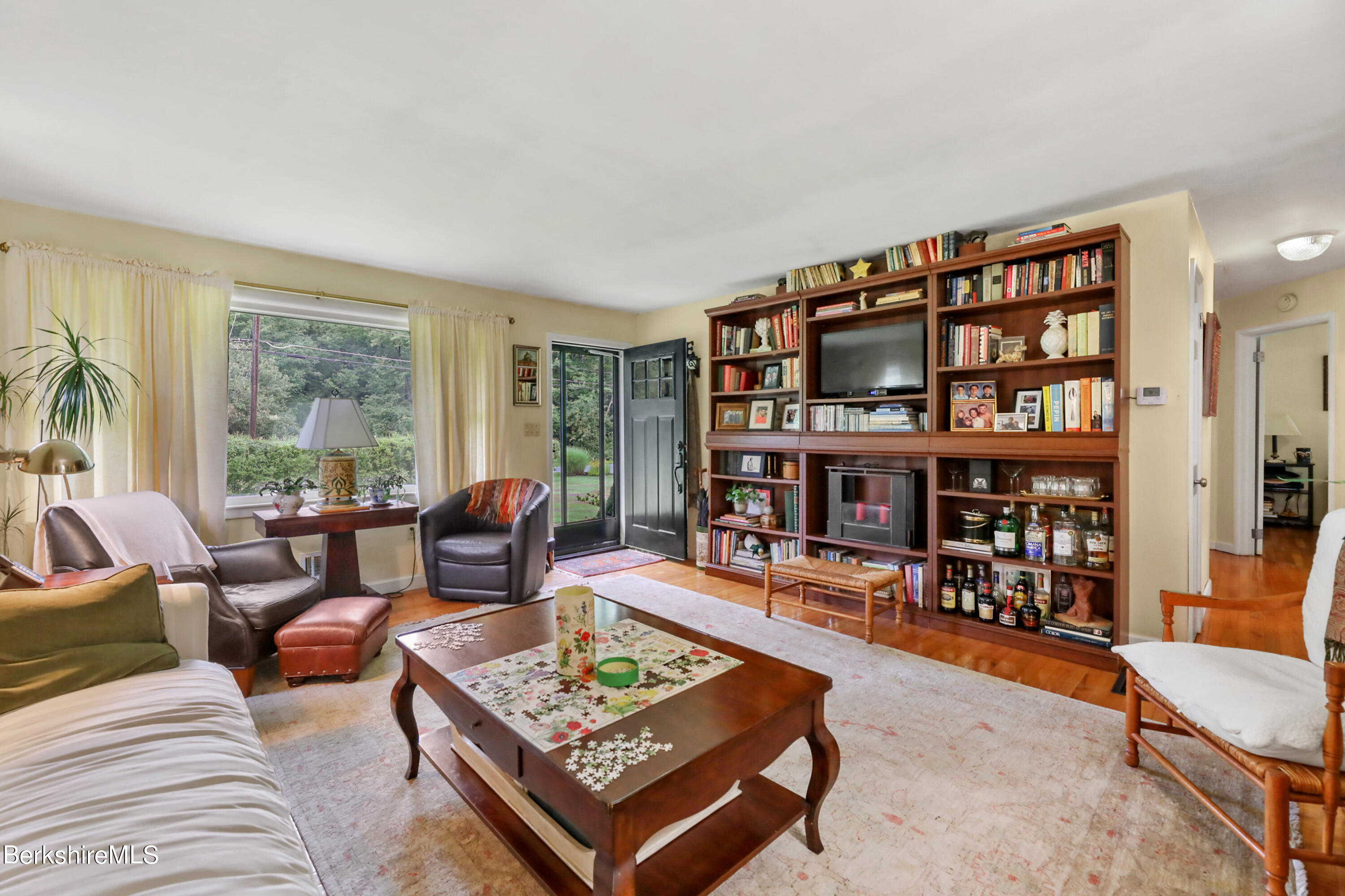 16 East New Lenox Road Lenox, MA 01240 - Photo 6 of 28 a living room with furniture and a book shelf