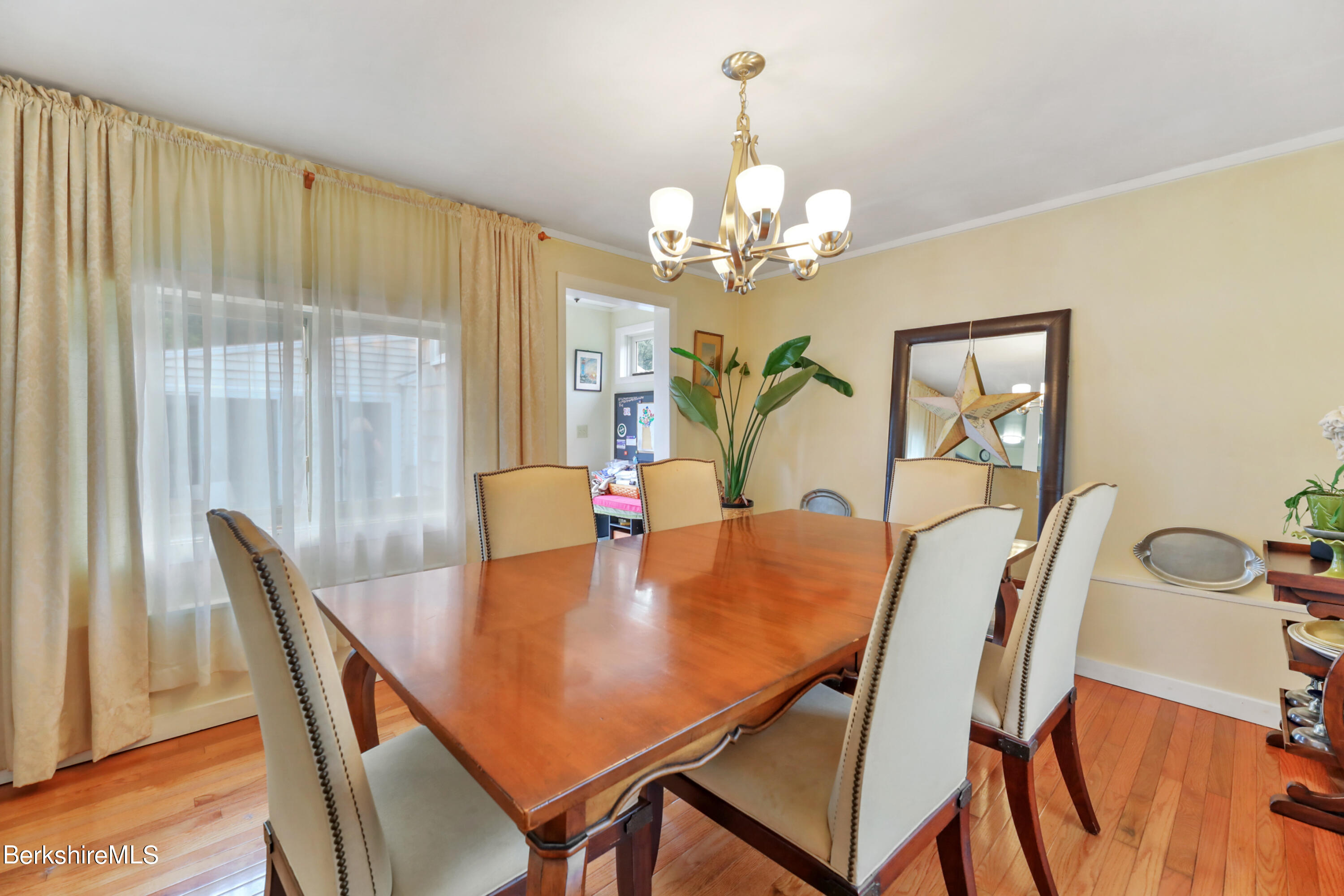 16 East New Lenox Road Lenox, MA 01240 - Photo 7 of 28 a view of a dining room with furniture a chandelier and wooden floor