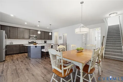 a kitchen with kitchen island a sink appliances and wooden floor