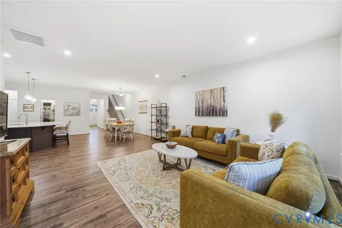 a living room with furniture and a lamp