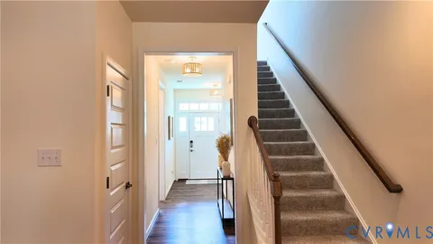 an aerial view of a house with garden space and a car parked on the road