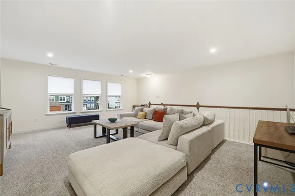 an aerial view of a house with garden space and a car parked on the road