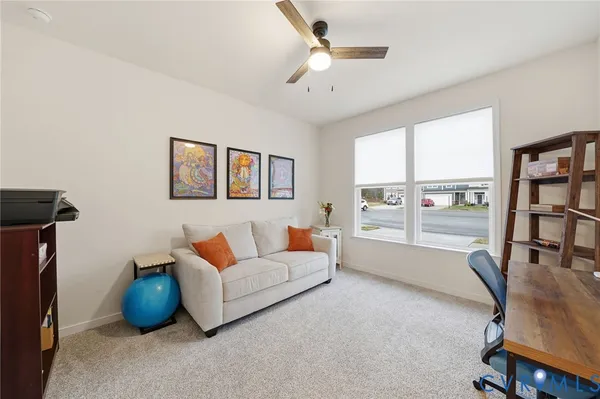a view of a livingroom with furniture and a window