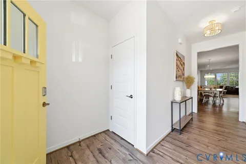 a kitchen with stainless steel appliances granite countertop a table chairs sink refrigerator and cabinets