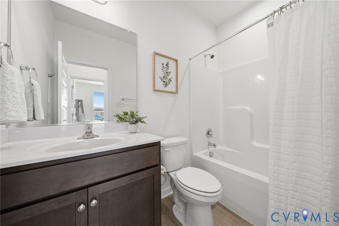 9204 Cerulean Place Richmond, VA 23238 - Photo 9 of 62 a bathroom with a sink a toilet a mirror and shower