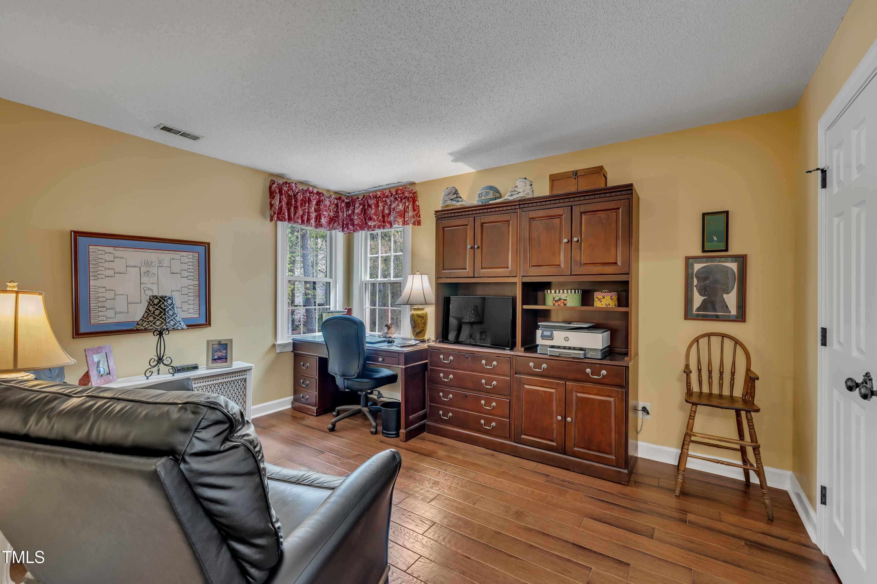 1100 Queensbury Circle Durham, NC 27713 - Photo 26 of 35 a living room with furniture and a wooden floor