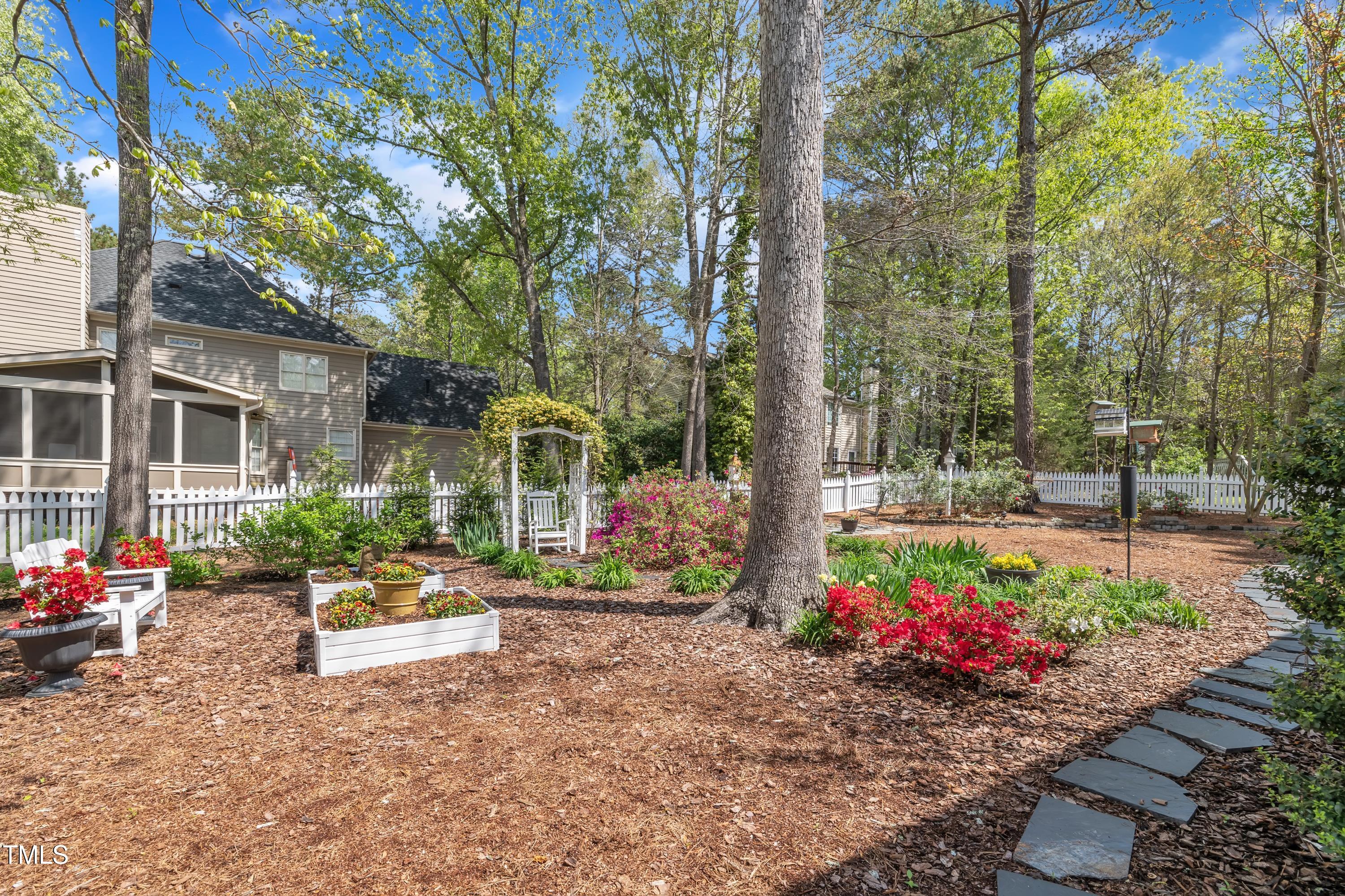 1100 Queensbury Circle Durham, NC 27713 - Photo 31 of 35 a view of a garden with flowers and trees