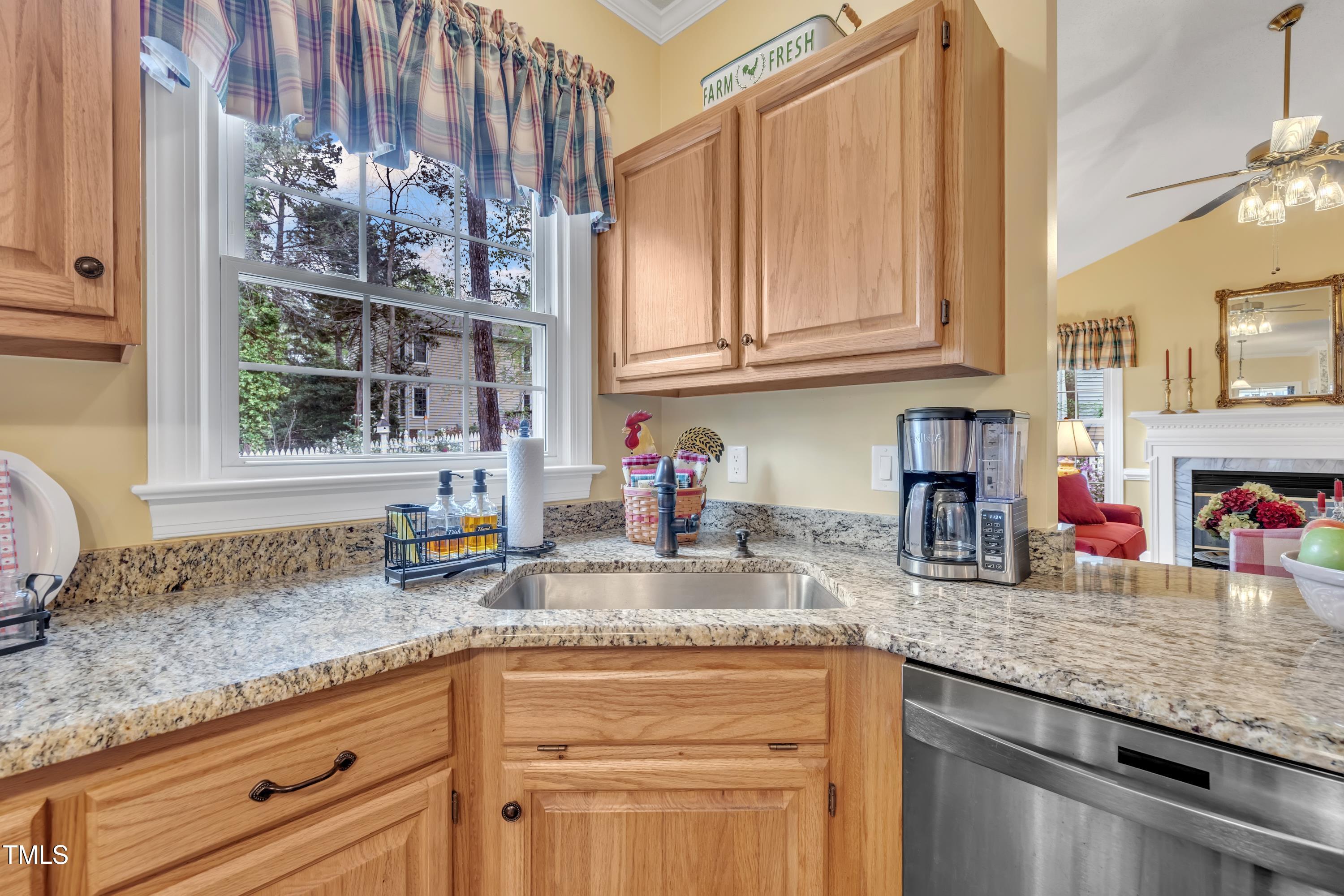 1100 Queensbury Circle Durham, NC 27713 - Photo 7 of 35 a kitchen with granite countertop stainless steel appliances a sink window and cabinets