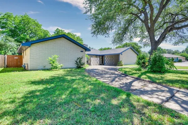 a view of house with backyard and garden