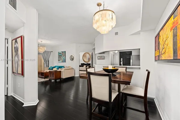 a view of a dining room with furniture and chandelier