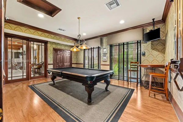 a large kitchen with granite countertop a sink and a stove top oven