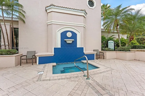 a view of swimming pool with outdoor seating and plants